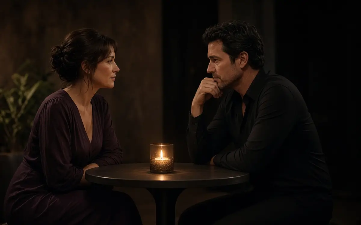 A dressed couple in profile at a small table, talking before the night.