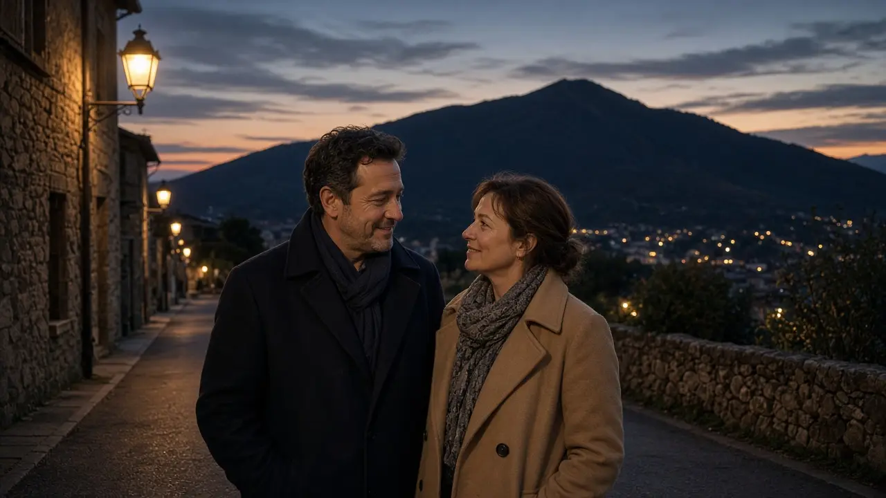 A dressed couple in coats on a mountain-town sidewalk at dusk.