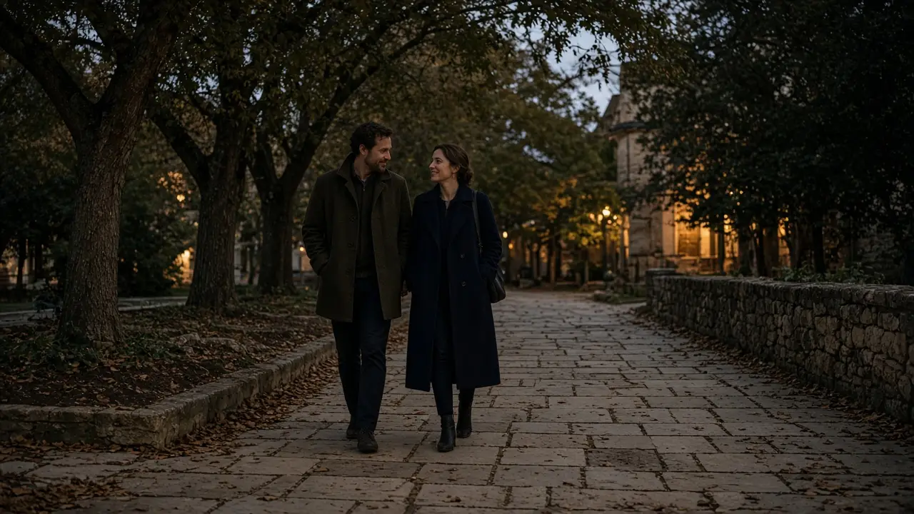 A dressed couple on a limestone sidewalk at dusk, college town trees, no signs.