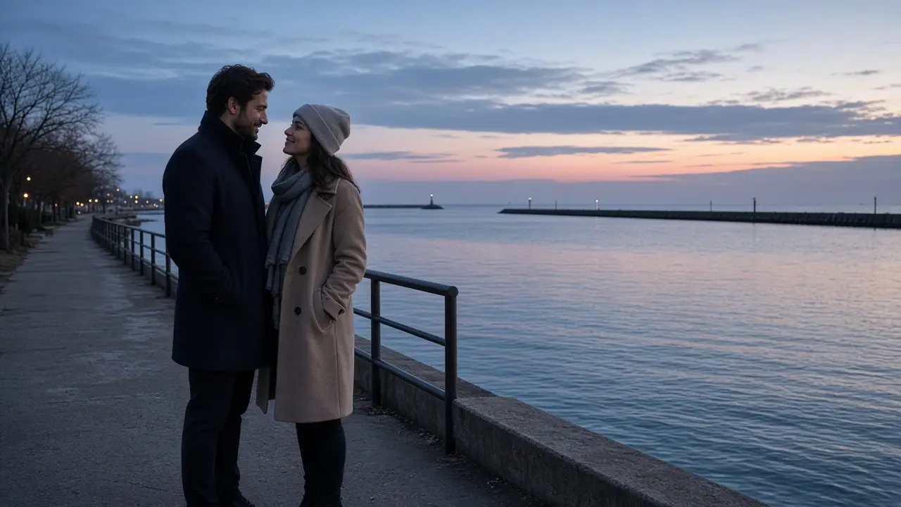 A dressed couple in coats on a lake harbor walk at dusk, a distant breakwater.